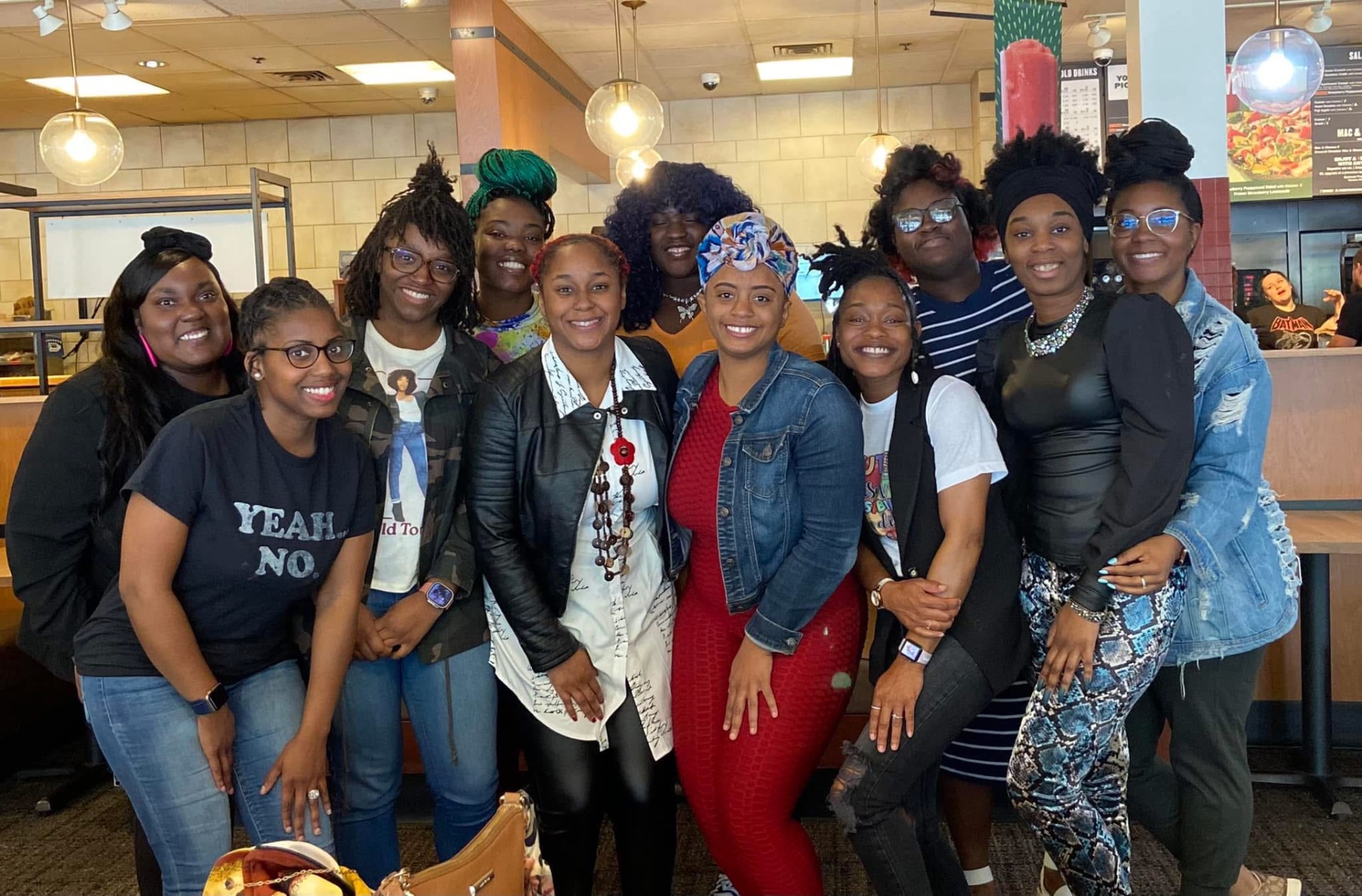 The Bride Tribe community — a sisterhood of women gathered together, smiling